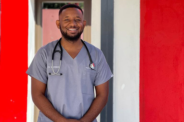 Young professional doctor Vincent Kambinda stands outside his practice in Rundu