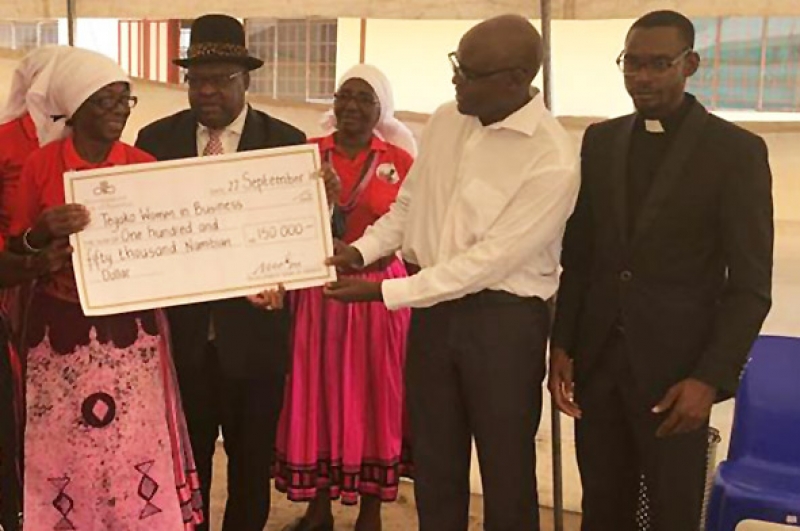 A dam for community development. Development Bank of Namibia CEO Martin Inkumbi recently handed over N$150,000 for construction of a dam to the Tegako 2020 Women in Business Co-operative, represented by Mrs. Teopolina Tegelela Negonga. The dam, at Olulongo in the Oshana Region will be used for Tilapia farming, and to irrigate crops. In the background, Tatekulu Herman Ndilimani Iipumbu, Chief of the Uukwambi Traditional Authority looks on. Rev. Nghilalulwa Wilhem is seen at the right.