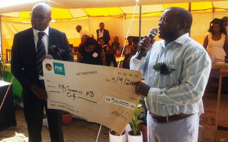 Caption: Good studying is good for development. Development Bank of Namibia CEO, Martin Inkumbi, (left) donated N$50,000 on behalf of the Bank to Romanus Kamunoko Secondary School in Rundu. The donation will contribute to construction of its school hall. The school currently rents premises when its learners have to write exams.